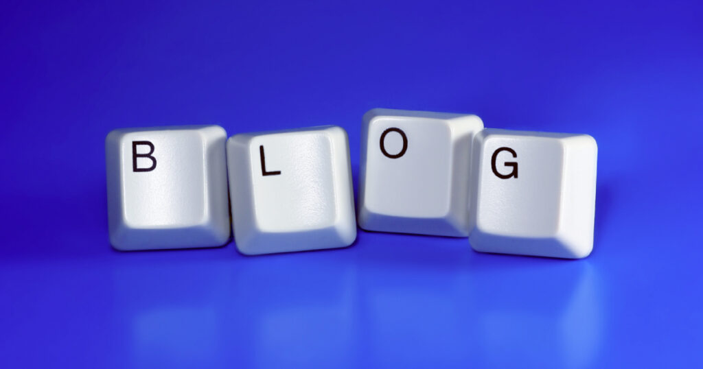 The word 'blog' made from 4 keys from a keyboard, on a blue background